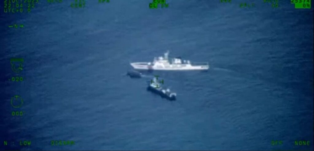 In this screenshot of a video taken by the Armed Forces of the Philippines some 2 kilometers east of Ayungin (Second Thomas) Shoal, China Coast Guard Vessel No. 5203 blocks a boat contracted by the AFP for a resupply mission in that area of the West Philippine Sea.
