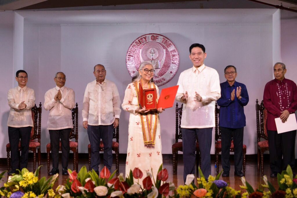 NEW UE PRESIDENT EMERITUS. Former Commission on Higher Education Chairperson Dr. Ester Albano Garcia (center, left) receives the stole, medallion and certificate as the newly installed president emeritus of the University of the East (UE) from Vice Chairman David Chua (center, right) in conferment rites held in UE Manila. Joining them onstage are UE President Zosimo Battad (third from left) and other high-ranking university officials.